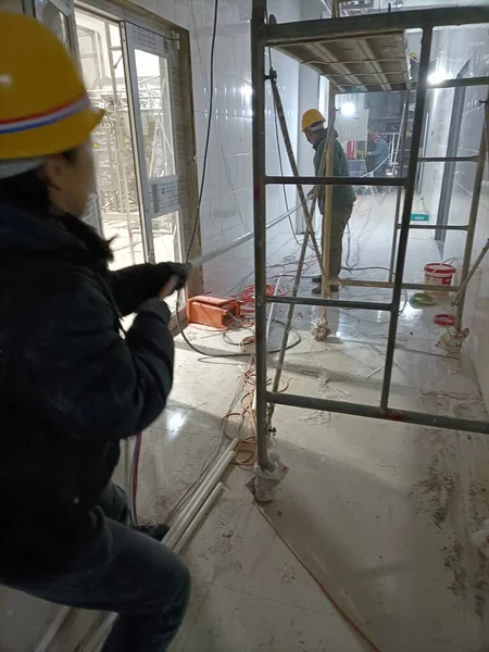 worker in a protective suit and a mask in the kitchen