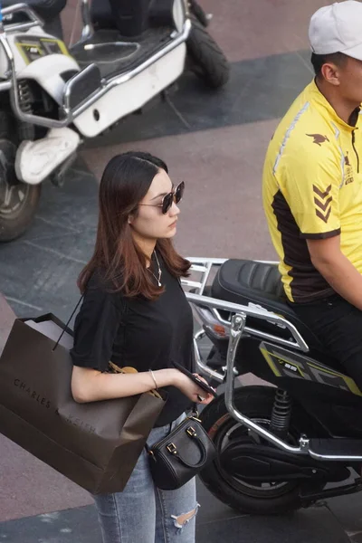 young woman with motorcycle in the garage