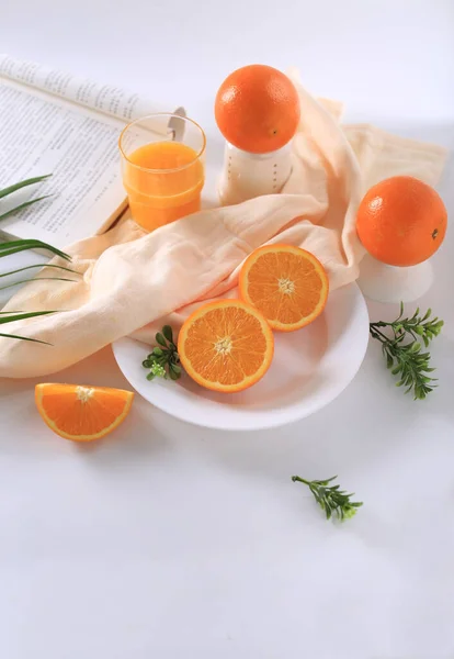 orange juice and oranges on white background