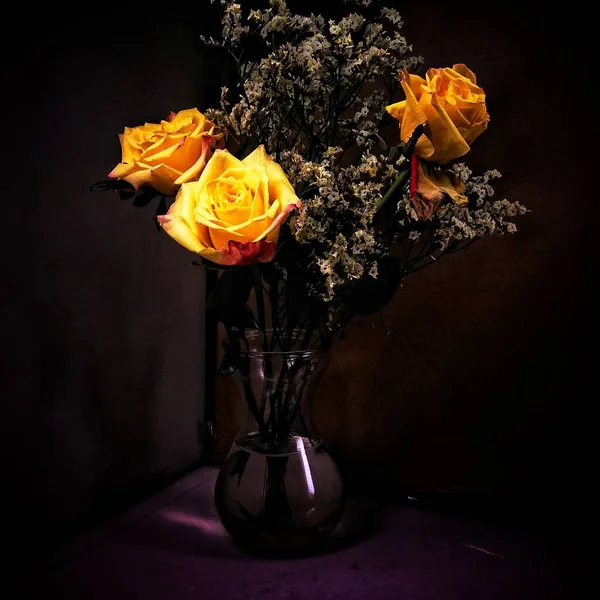 still life with roses and a bouquet of yellow and black