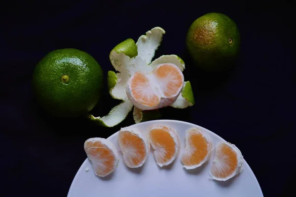 fresh ripe juicy and sliced citrus fruits on black background