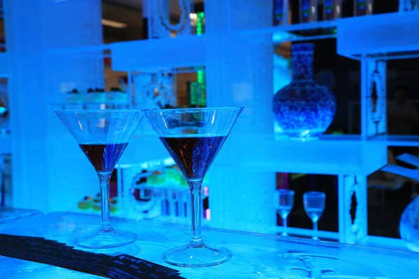 glass of blue cocktail on the background of the bar