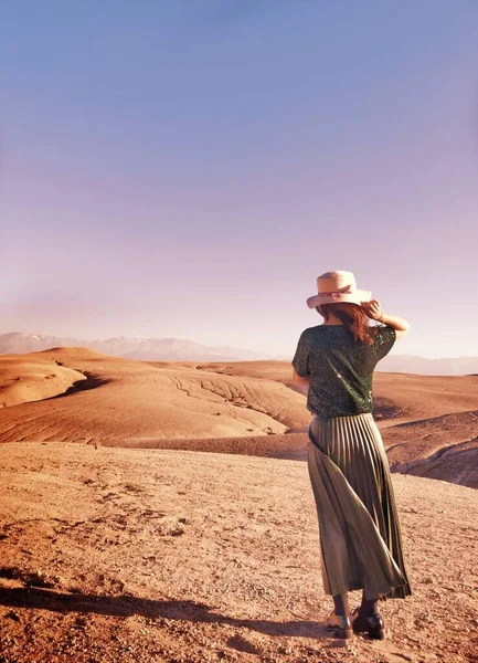 young woman in a desert with a backpack