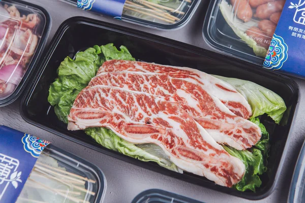 close up of a tray of meat in a box