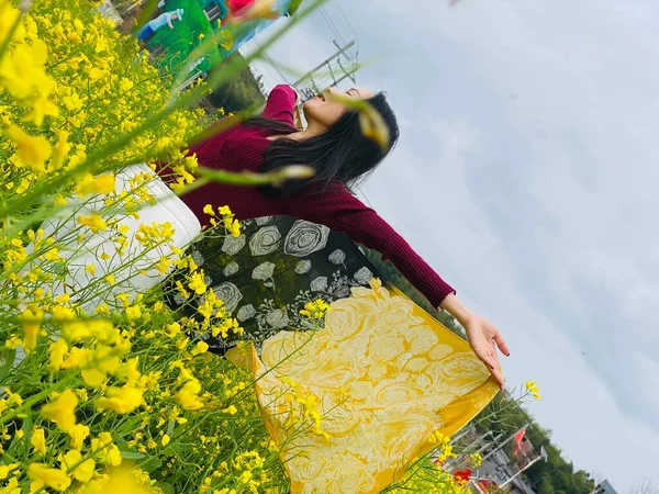 woman with flowers in the field