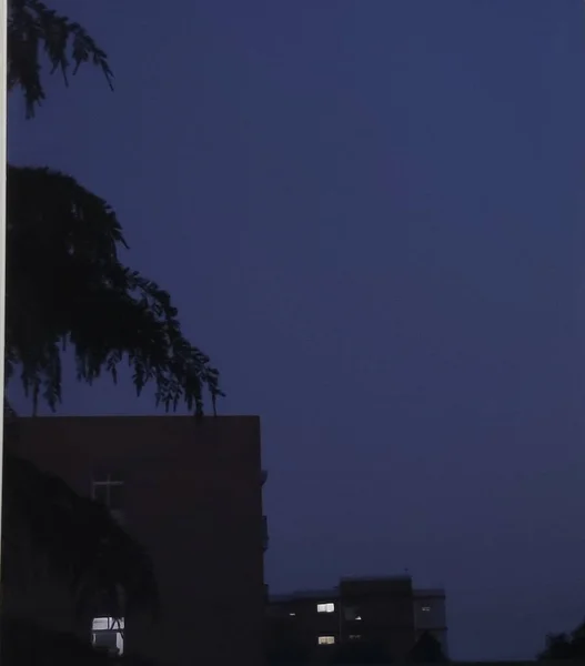 silhouette of a tall house in the night sky