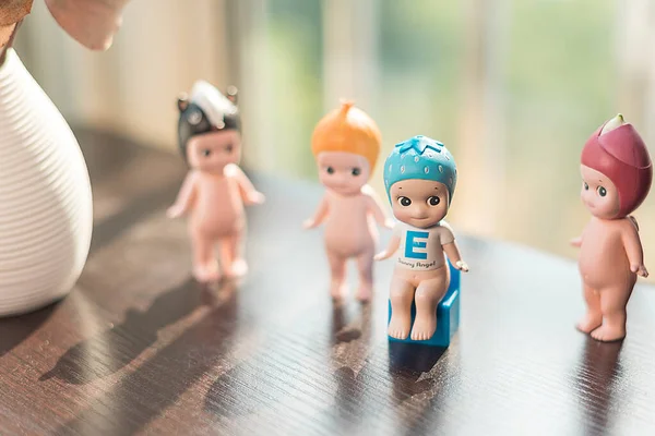 toy doll with toys on the background of the wooden table