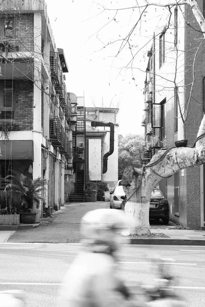 black and white photo of a street in the city