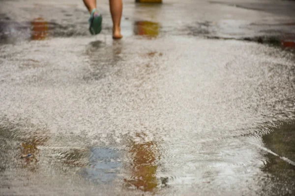 woman walking in the puddle of the river
