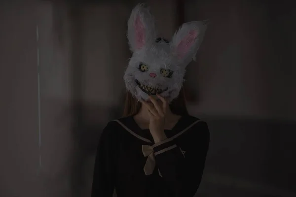 halloween girl with rabbit in the hands of a cat