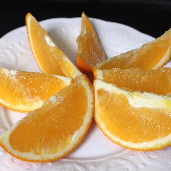fresh sliced orange and lemon slices on a black background