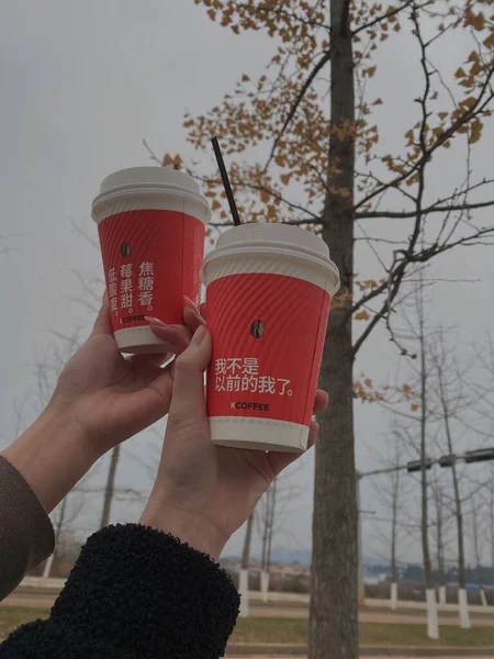 coffee cup with red and white cups on the background of the city