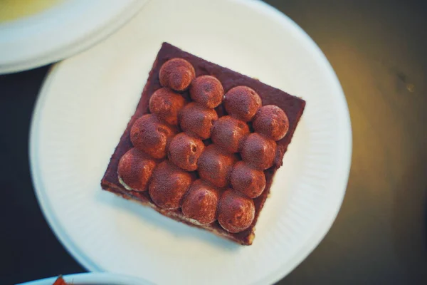 chocolate truffles with nuts and cocoa powder on a white plate