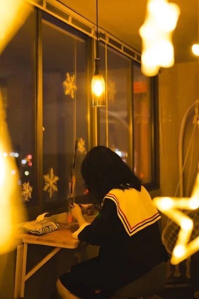 young woman in a cafe with a candle