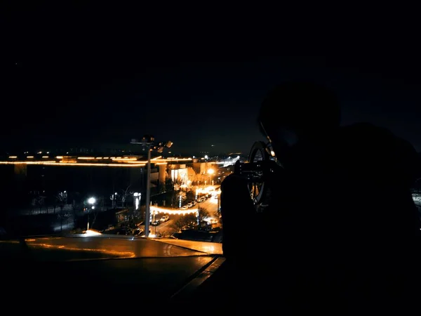 silhouette of a man with a camera on the background of the night sky