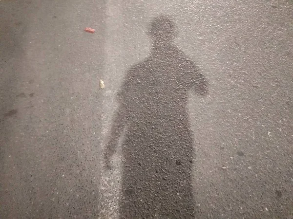 a closeup shot of a wet road with a white sand