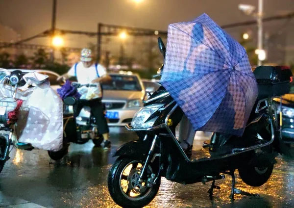 a man riding a motorcycle in the city