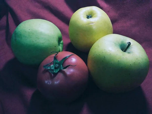 green and red apples on a white background