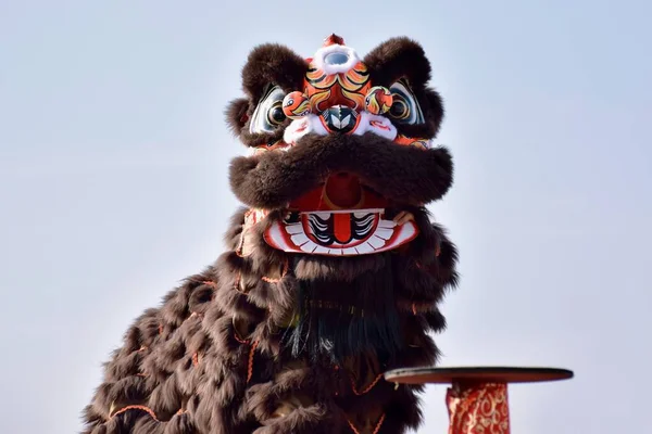 chinese new year, a monkey, a lion, a face, a mask, a toy, a