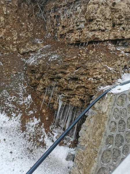 concrete wall with a shovel and a puddle of water