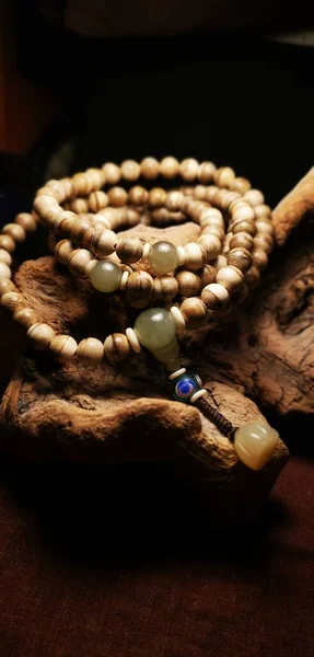 close up of a rosary beads on a wooden background
