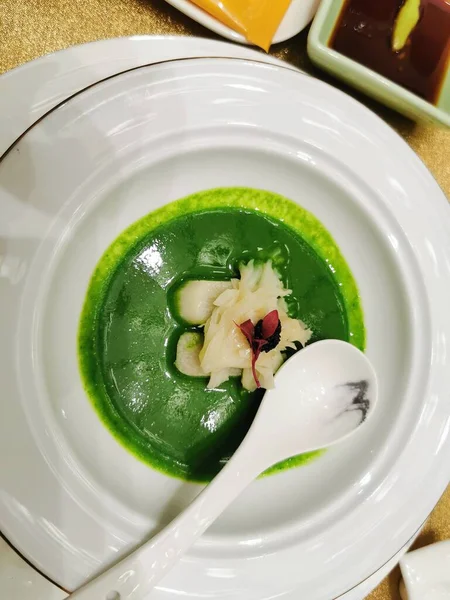 green soup with chicken and vegetables