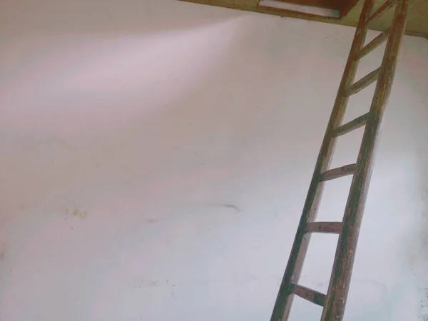 old wooden ladder with a red and white paint