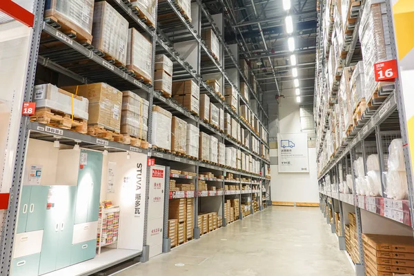 warehouse shelves with boxes in the background