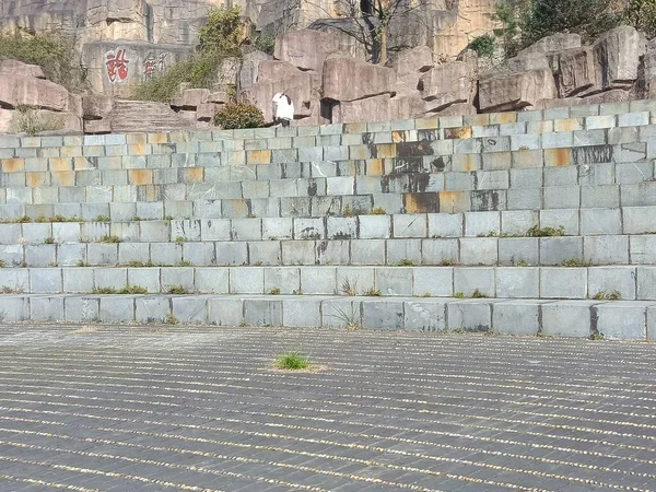 old brick wall with a large stone