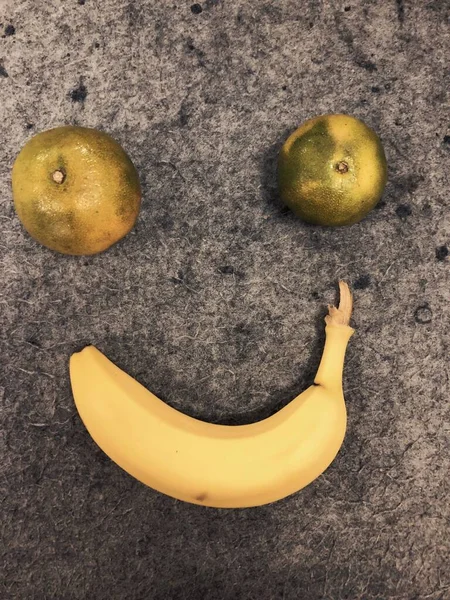 a face of a banana with a smile on a white background