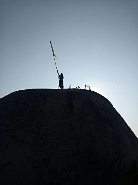 silhouette of a man with a sword on the background of the mountain