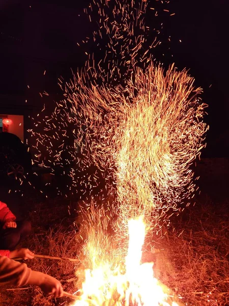 sparks welding metal with a fire