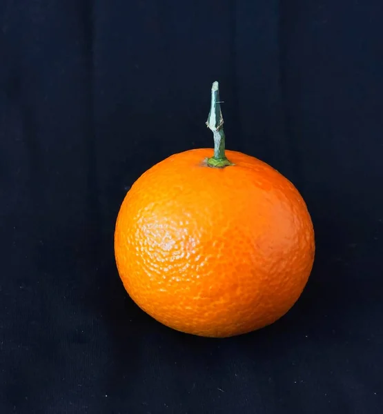 fresh ripe orange on a black background