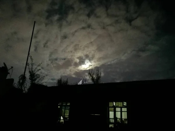 silhouette of a house in the night sky