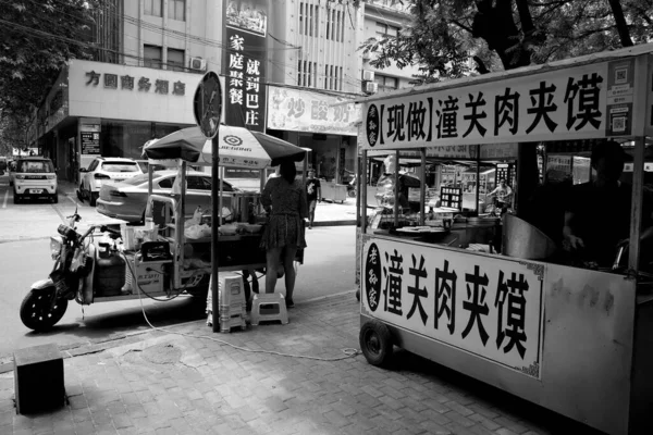 black and white photo of a street cafe