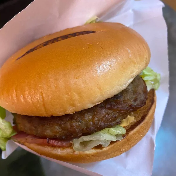 close up view of delicious burger with meat and vegetables