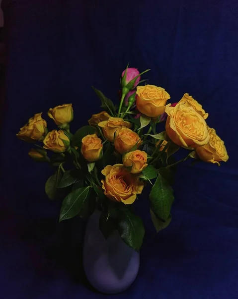 beautiful bouquet of roses in a vase on a dark background