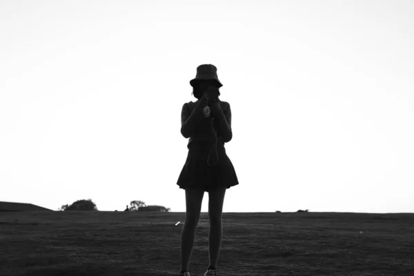 silhouette of a young woman with a backpack on the beach