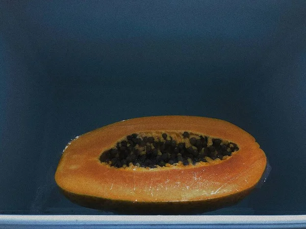 ripe juicy papaya on a black background