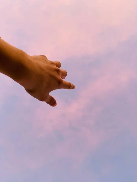 hand of a man and woman hands on the sky background