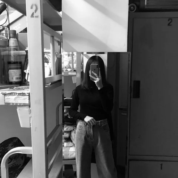 young woman in black and white clothes posing in the kitchen