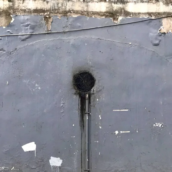 old rusty metal door with a white wall