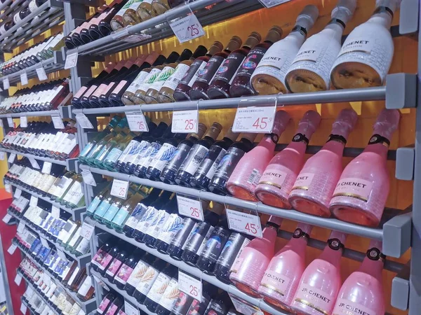 shelves with different types of wine in the store
