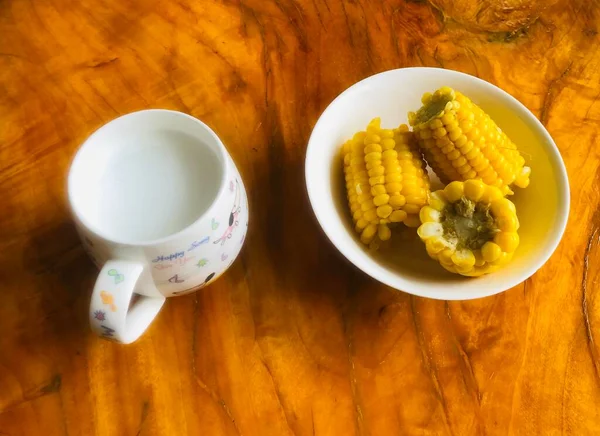 corn and hot sweet yellow juice on a wooden background