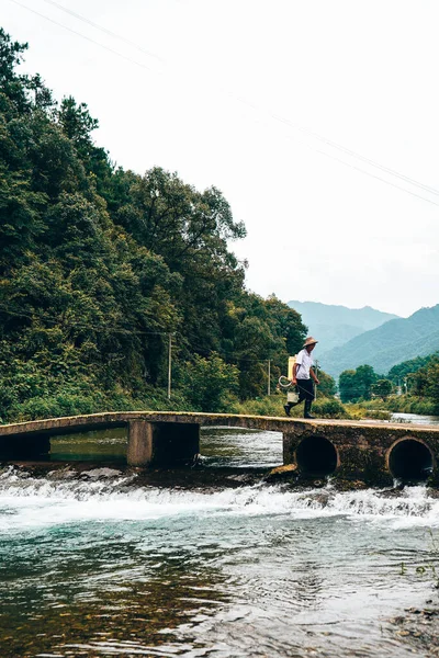 man in a boat with a backpack on the river