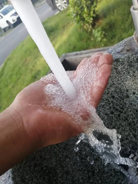 washing hands with soap and water drops on the hand