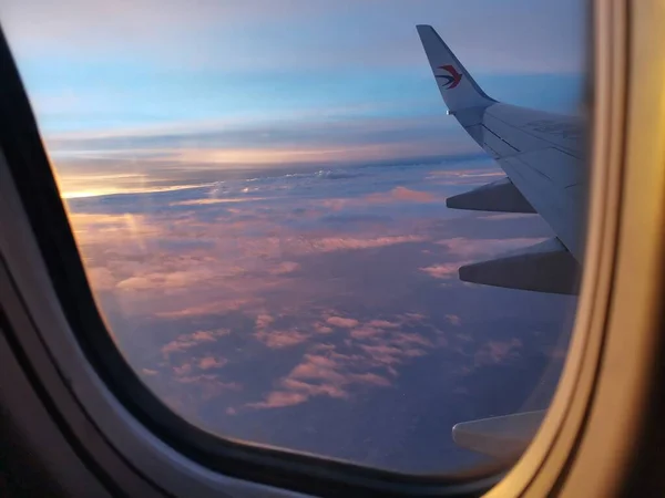 view from airplane window, wing, aircraft, plane, sky, clouds, blue cloudy day