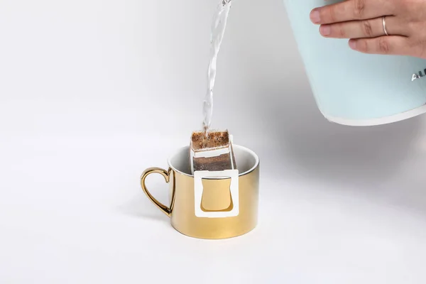 pouring coffee into a cup on a white background