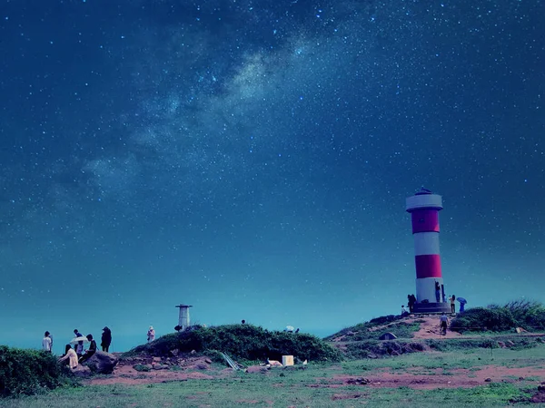 beautiful night sky with stars and lighthouse