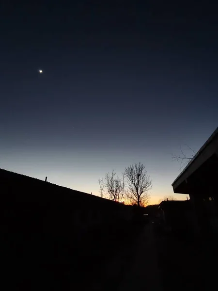 silhouette of a house in the night sky